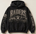 Raiders Archive Crest washed black hoodie front with distressed cream skyline and sleeve artwork